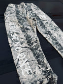 Hostility Camouflage pants with branding on a dark surface