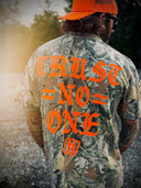 Camo Tee with Orange lettering that reads, "Trust No One" Hostility Clothing 